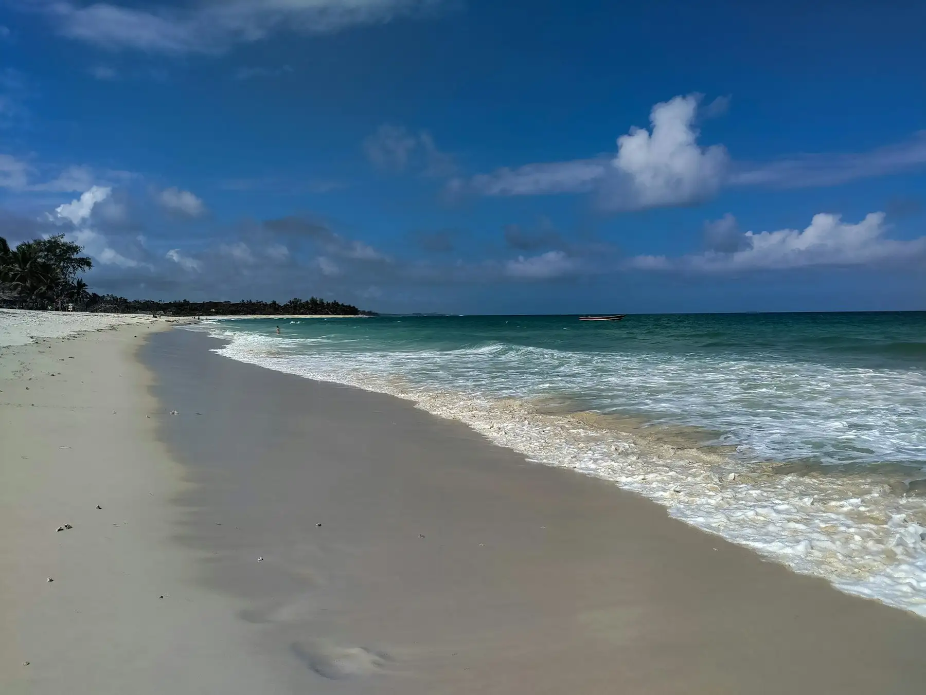 White sand and turquoise water inside the reef at Diani Beach.